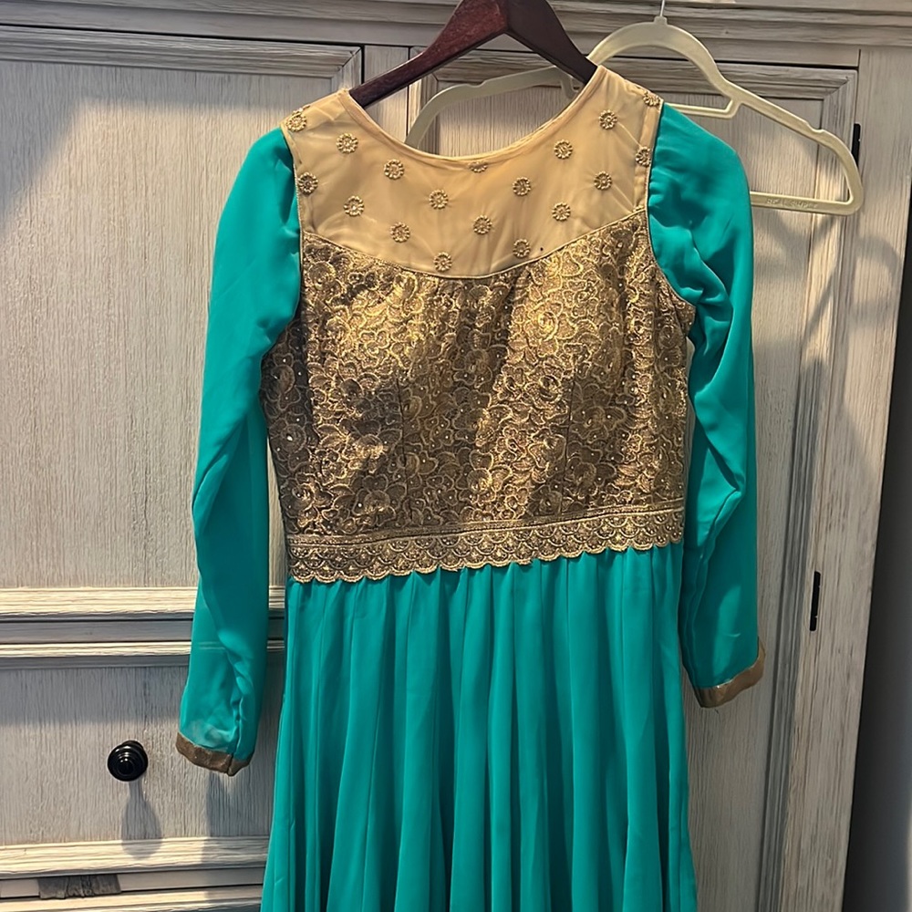 Long dress with gold design.